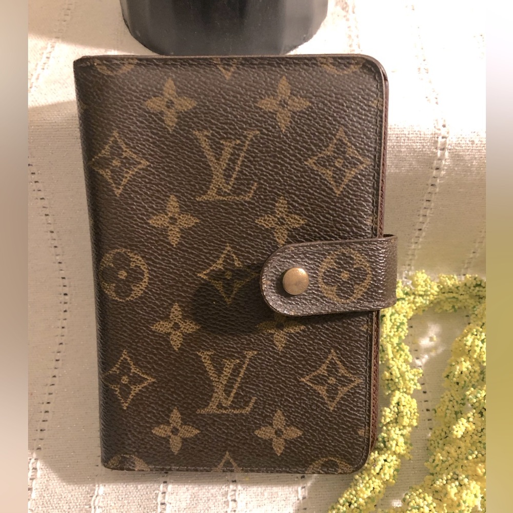 Authentic Louis Vuitton monogram wallet with zippered compartment.